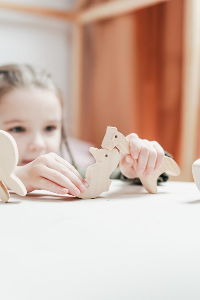 Mastering the First Impression: Your intriguing post title goes here Young girl playing creatively with wooden animal toys in an indoor setting.